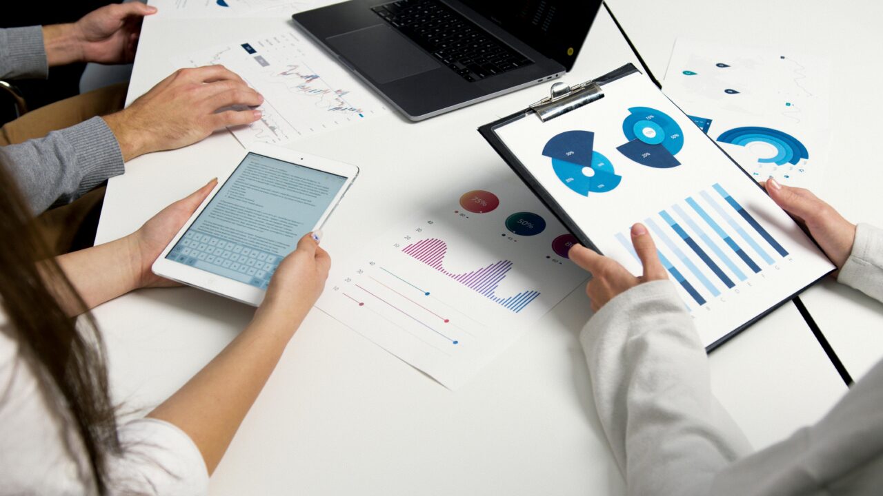 What is employee engagement: a team looking at sheets of charts and metrics.