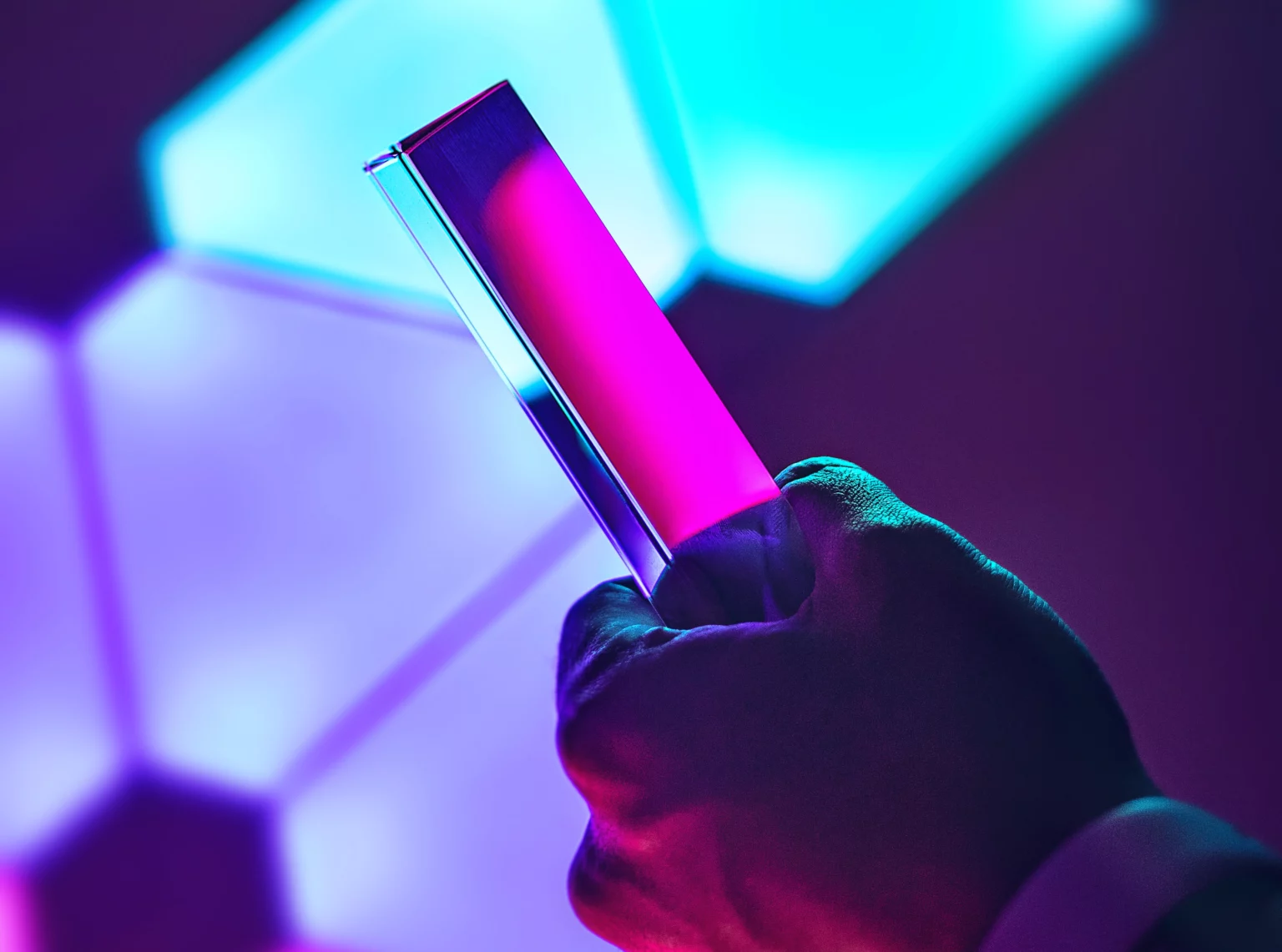 A smartphone against a neon-lit background.